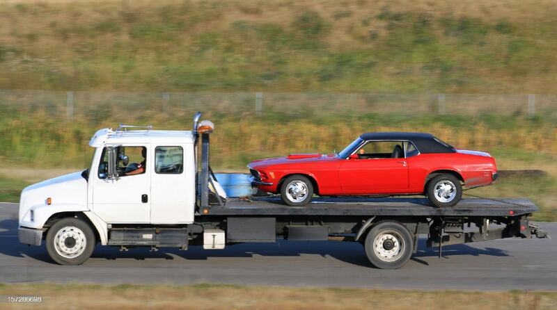 red car on tow truck